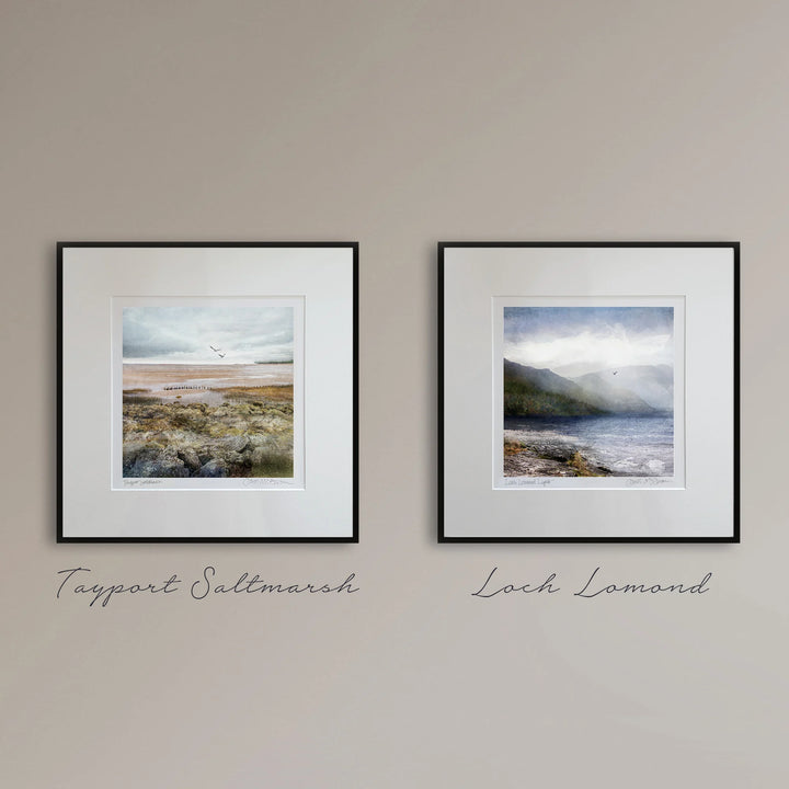 2 art prints, Tayport & Loch Lomond in fine black frames on a neutral beigh wall.